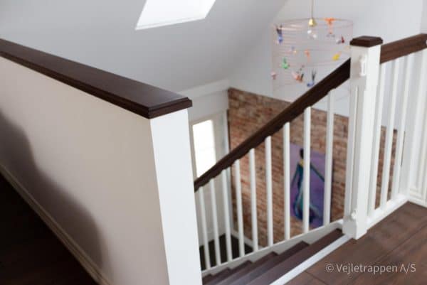Hvid trætrappe designet som en kvartsvingstrappe med trappetrin og trappegelænder i mørk eg fra Vejletrappen